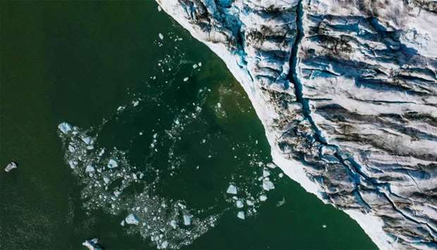 An aerial picture taken shows bergy bits and growlers floating in front of the Apusiajik glacier, near Kulusuk (aslo spelled Qulusuk), a settlement in the Sermersooq municipality located on the island of the same name on the southeastern shore of Greenland.