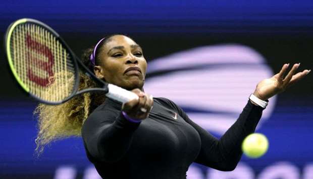 Serena Williams of the United Sates returns the ball to Maria Sharapova of Russi