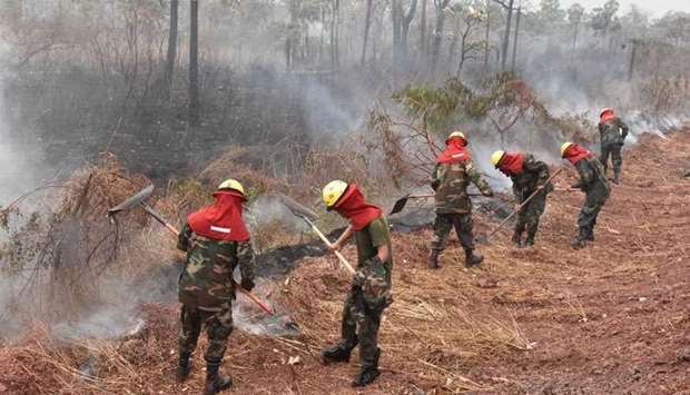 Bolivian soldiers combat forest fires in Otuquis National Park, in the Pantanal ecoregion of southeastern Bolivia