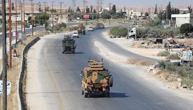 Turkish military vehicles drive down a road in Syria's northern province of Idlib yesterday. AFP