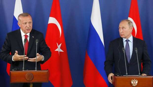 Turkish President Recep Tayyip Erdogan (L) speaks as Russian President Vladimir Putin (R) looks on during a joint news conference