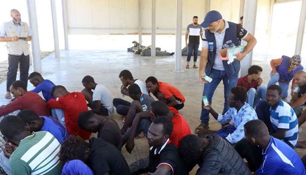 Rescued migrants receive food aid at a coast guard point in Khoms, some 100 kilometres from the Libyan capital Tripoli. AFP