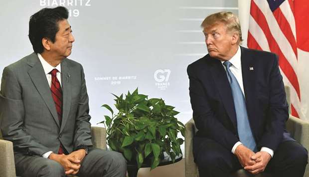 Japanu2019s Prime Minister Shinzo Abe (left) and US President Donald Trump look at each other during a bilateral meeting on the sidelines of the G7 summit in Biarritz, south-west France. Japan signalled it wanted to lay to rest the threat of new auto tariffs before agreeing to a final trade deal with Trump, after he left the door open for slapping levies on the nearly $50bn sector.