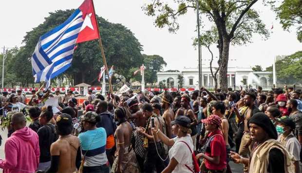 Papuans take part in a rally in front of the presidential palace and army headquarters in Jakarta