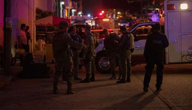 Soldiers gather near a crime scene following a deadly attack at a bar by unknown assailants in Coatzacoalcos