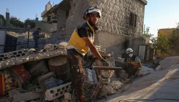 Members of the Syrian Civil Defence (White Helmets) look for survivors under the rubble of a building following a reported airstrike by Syrian regime forces in Maar Shurin on the outskirts of Maaret al-Numan in northwest Syria yesterday.