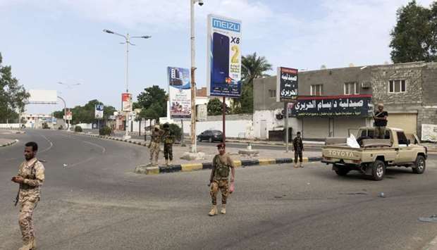 Fighters of the Security Belt Force patrol a street in an area near the Aden International airport