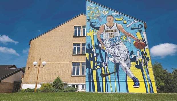 This photo taken on June 25, 2019, shows a mural depicting Nikola Jokic painted on a wall of his former school in his hometown of Sombor. (AFP)