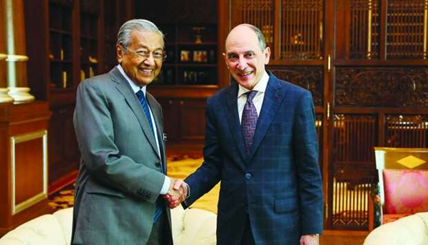 Qatar Airways Group Chief Executive Akbar al-Baker shaking hands with Malaysian Prime Minister Mahathir bin Mohamad during a meeting in Kuala Lumpur.