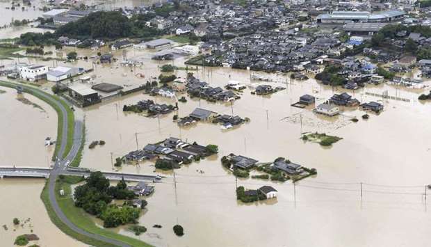 An aerial view shows submerged houses and facilities at a flooded area in Takeo, Japan