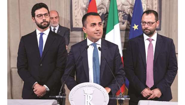 5-Star Movement leader Luigi di Maio speaks to the media as Francesco Du2019Uva and Stefano Patuanelli look on at the Presidential Palace in Rome.