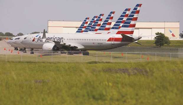 American Airlines Group Boeing 737 MAX planes sit parked outside of a maintenance hangar at Tulsa International Airport (TUL) in Tulsa, Oklahoma. Boeing has had to divert resources to the 737 MAX from across the company as it works to win approval from aviation regulators for its software upgrade.
