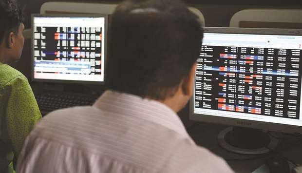 Traders monitor share prices at the Bombay Stock Exchange. The Sensex dropped 1% to 37,068.93 points yesterday.