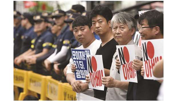 South Korean protesters hold placards reading u201cNo Abe!u201d during a rally against Japanu2019s decision to remove South Korea from a so-called white list of favoured export partners, in front of the Japanese embassy in Seoul yesterday.