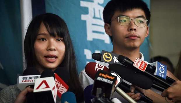 Pro-democracy activists Agnes Chow (L) and Joshua Wong (R) speak to the press after they were released on bail at the Eastern Magistratesu2019 Courts in Hong Kong