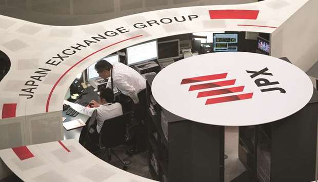 Employees work at the Tokyo Stock Exchange. The Nikkei 225 closed up 1.2% to 20,704.37 points yesterday.