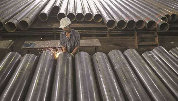 Sparks fly as a worker grinds the edge of a steel tube at the finishing line of the steel tube mill at the Steel Authority of India Rourkela Steel Plant in Odisha. Indiau2019s economy expanded just 5% year-on-year, official data showed yesterday, far below the 5.7% forecast in a Reuters poll of economists.
