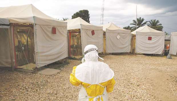 A health worker wearing Ebola protection gear walks towards the Biosecure Emergency Care Unit (CUBE) at the ALIMA (The Alliance for International Medical Action) Ebola treatment centre in Beni, in the Democratic Republic of Congo.