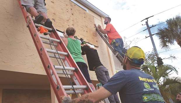 Workers board up an apartment building in Fort Pierce, Florida.