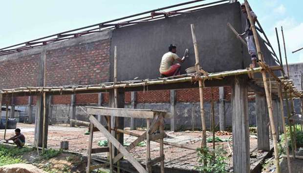 This photo taken Thursday, shows labourers working on a new detention centre being built for people who are not included in a ,citizens register, in Kadamtola Gopalpur village, in Goalpara district, some 170km from Guwahati, the capital city of Indiau2019s northeastern state of Assam.