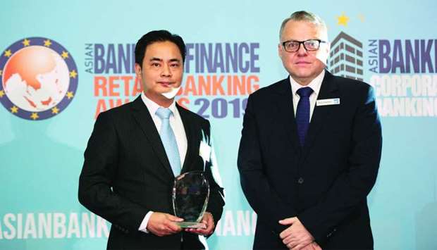 Doha Bank Singapore chief representative officer Ivan Lew receiving the two awards during the ceremony