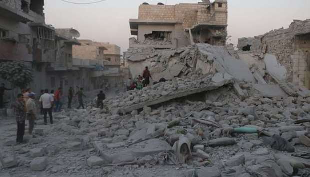 Residents inspect the rubble of damaged buildings, looking for victims, after a deadly airstrike, said to be in Maarat al-Numan, Idlib province, Syria on August 28