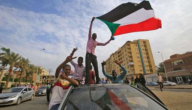 Sudanese protesters wave their national flag during a demonstration called for by the Sudanese Professionals Association (SPA) to denounce the July 29 Al-Obeid killings, in the capital Khartoum on Thursday.