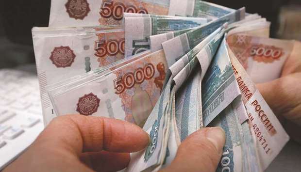 An employee counts rouble banknotes at a private shop selling home appliances in Krasnoyarsk, Russia.