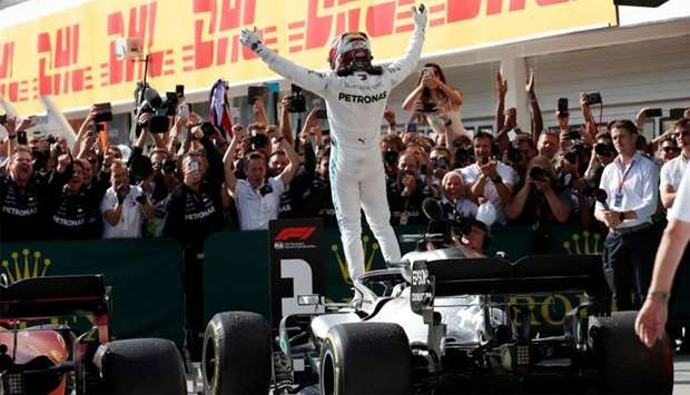 Mercedes' Lewis Hamilton celebrates winning the Hungarian Grand Prix standing on his car