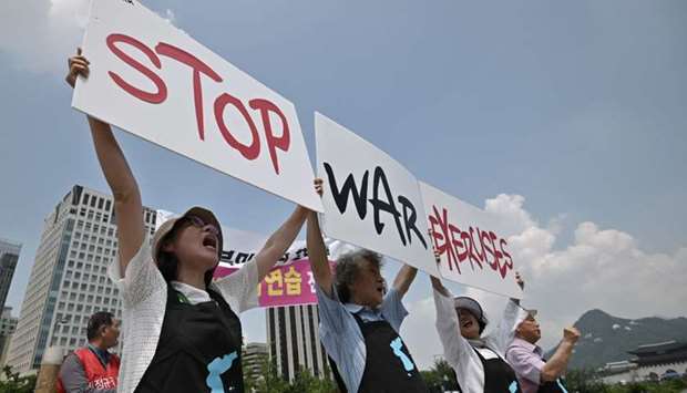 Anti-war activists hold placards reading ,Stop War Exercises,, during a rally against planned South Korea-US annual joint military exercises near the US embassy in Seoul