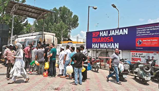 Residents stand in a queue at a petrol station in Srinagar yesterday.