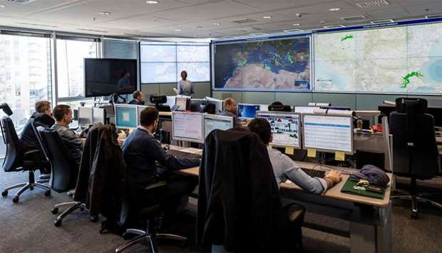 Employees working in the situation room at the headquarters of the European Union border force Frontex in Warsaw, Poland