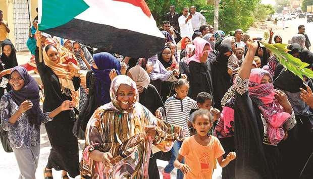 Sudanese demonstrators celebrate in Khartoum yesterday.