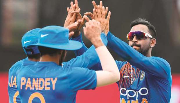Krunal Pandya (right) of India celebrates the dismissal of Nicholas Pooran of West Indies in the second T20I at the Central Broward Regional Park Stadium in Lauderhill, Florida, on Sunday. (AFP)