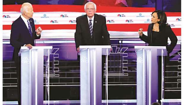Former vice-president Joe Biden and Senator Kamala Harris debate racial issues as Senator Bernie Sanders looks on.