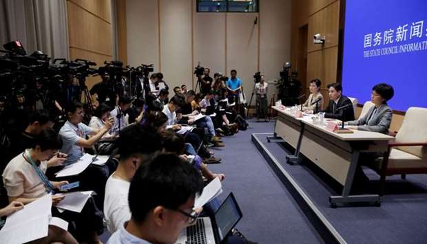 Yang Guang (C) and Xu Luying (R) of the Hong Kong and Macau Affairs Office of the State Council attend a news conference on the current situation in Hong Kong, in Beijing, China