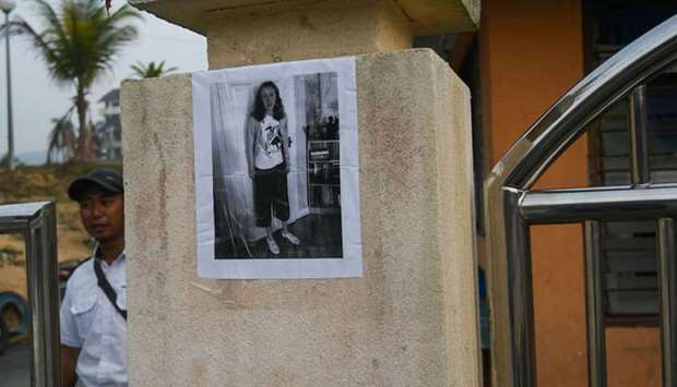 A picture of the missing 15-year-old Nora Quoirin from London, is seen posted by the gate of a building in Seremban. AFP