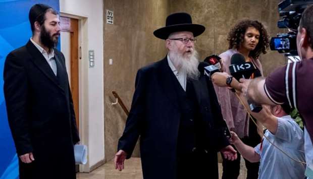 Israeli deputy Health Minister Yaakov Litzman speaks to members of the media before he enters the offices of Israeli Prime Minister Benjamin Netanyahu to attend the weekly cabinet meeting in Jerusalem on May 26.