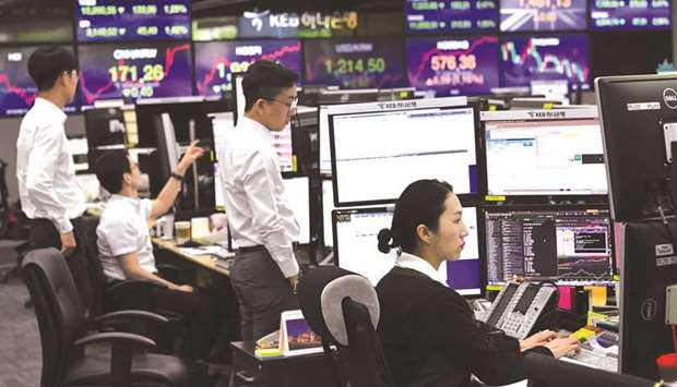 Currency dealers monitor exchange rates in a trading room at the KEB Hana Bank in Seoul.