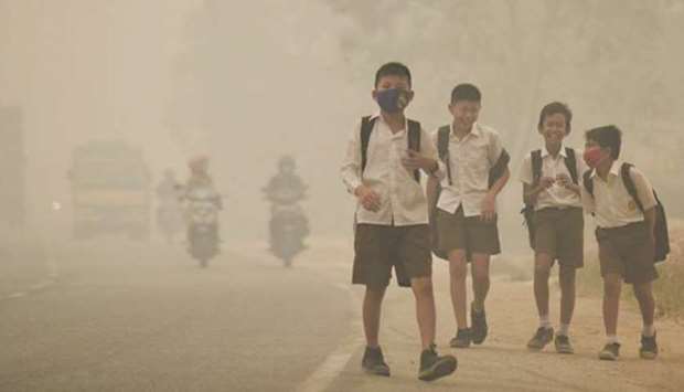 Students walking after being released from school early due to the haze in Jambi, Indonesia, in this September 2015 file photo.