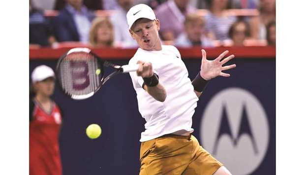 Kyle Edmund of Great Britain hits a return against Nick Kyrgios (AFP)