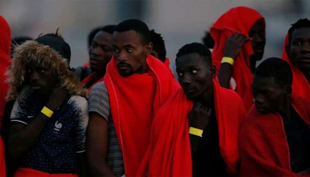 Migrants, intercepted off the coast in the Mediterranean Sea, wait to disembark from a rescue boat at the port of Malaga