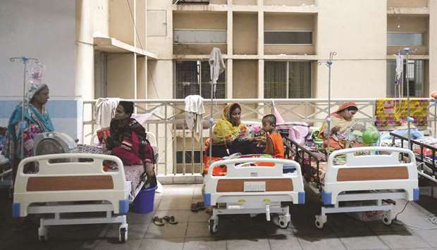 Bangladeshi patients suffering from dengue fever rest on beds at the Mugda Medical College and Hospital in Dhaka yesterday.