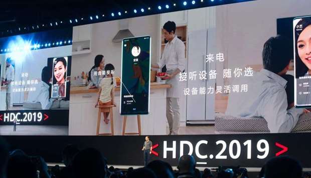 Richard Yu (bottom C), head of Huawei's consumer business, is seen in front of a giant screen as he unveils the company's new HarmonyOS operating system during a press conference in Dongguan, Guangdong province