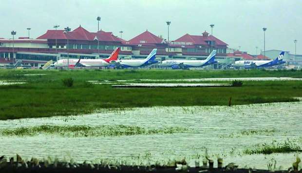 Airplanes are pictured as they are parked next to flood waters on the tarmac of the Cochin International Airport Friday. PICTURE: AFP.