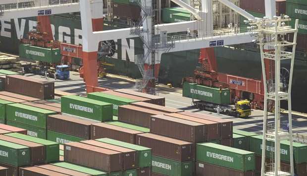 Containers are transferred from a cargo ship to trucks at the international cargo terminal at the port of Tokyo. Japanu2019s gross domestic product grew 0.4% from the previous quarter, beating analystsu2019 median forecast of 0.1%, the Cabinet Office said yesterday.