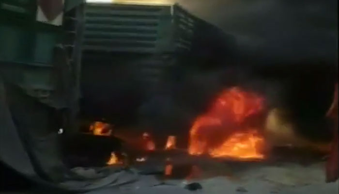 An image grab from the footage that shows the trucks burning