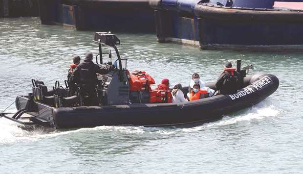 Migrants are brought to Dover harbour by Border Patrol yesterday.