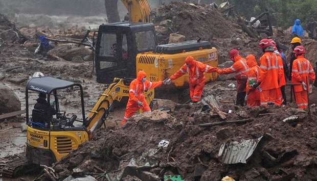 Rescue workers look for survivors at the site of a landslide during heavy rains in Idukki yesterday.