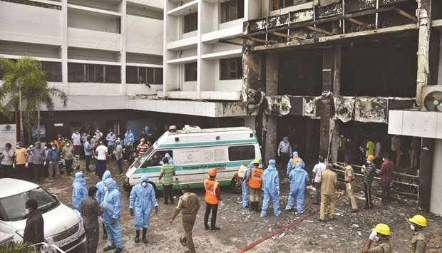 Rescue workers look for survivors after a fire broke out in a hotel that was being used as a coronavirus disease facility in Vijayawada yesterday.